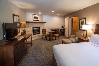 a hotel room with a bed and a fireplace at Holiday Inn Express South Lake Tahoe by IHG in South Lake Tahoe