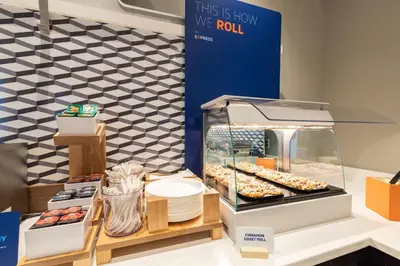 a display case with donuts and other pastries at Holiday Inn Express & Suites Yosemite Park Area by IHG in Chowchilla