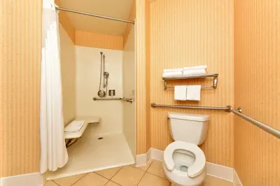 a bathroom with a toilet and a shower at HOLIDAY INN EXPRESS & SUITES ELK GROVE CENTRAL - HWY 99 by IHG in Elk Grove