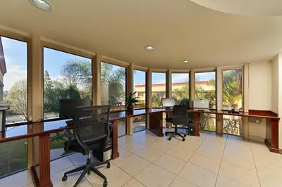 an office with a desk and chairs and windows at Holiday Inn Rancho Cordova - Northeast Sacramento by IHG in Rancho Cordova