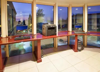 an office with a desk with a computer on it at Holiday Inn Rancho Cordova - Northeast Sacramento by IHG in Rancho Cordova