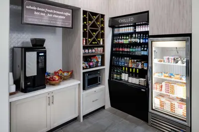 a coffee shop with a refrigerator and a drink cooler at Hilton Garden Inn Folsom in Folsom