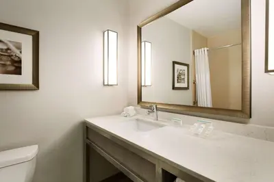 a bathroom with a sink and a mirror at Hilton Garden Inn Roseville in Roseville
