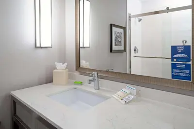 a bathroom with a sink and a mirror at Hilton Garden Inn Roseville in Roseville