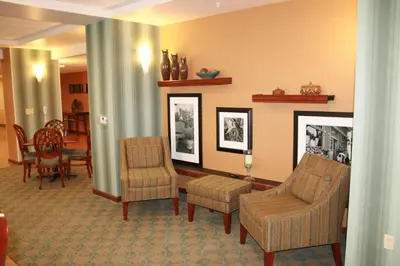 a living room with two chairs and a table at Hampton by Hilton in Brentwood