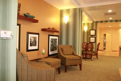 a waiting room with chairs and a table at Hampton by Hilton in Brentwood