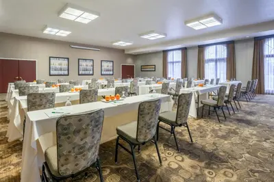a conference room with tables and chairs and windows at Holiday Inn Auburn by IHG in Auburn