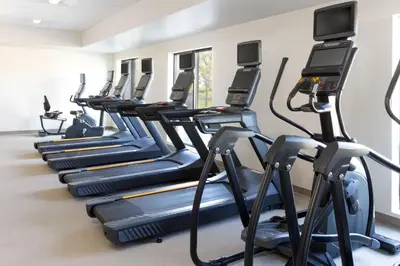 a row of cardio machines in a gym at SpringHill Suites by Marriott Sacramento Roseville in Roseville