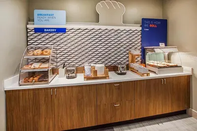 a bakery with a counter with donuts on it at Holiday Inn Express Hotel & Suites Minden by IHG in Minden