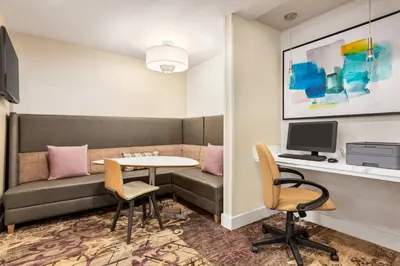 a room with a couch and a table and chairs at Residence Inn by Marriott Roseville in Roseville