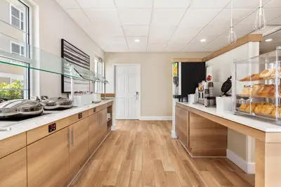 a large kitchen with wooden cabinets and wooden floors at Residence Inn by Marriott Roseville in Roseville