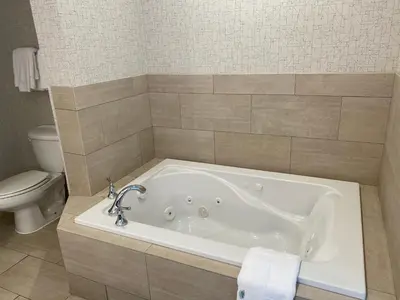 a bath tub in a bathroom with a toilet at Holiday Inn Express Hotel & Suites El Dorado Hills by IHG in El Dorado Hills