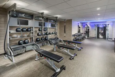 a fitness room with several treadmills and weights at Courtyard by Marriott Roseville in Roseville
