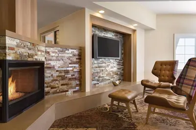 a living room with a fireplace and a tv at Residence Inn Sacramento Folsom in Folsom