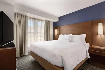 a hotel room with a large bed and a flat screen tv at Residence Inn Sacramento Folsom in Folsom