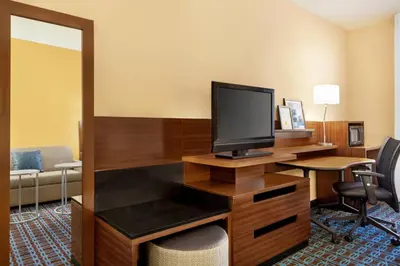 a hotel room with a desk with a television at Fairfield Inn by Marriott Roseville in Roseville
