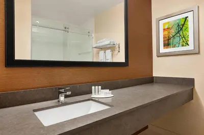 a bathroom with a sink and a large mirror at Fairfield Inn by Marriott Roseville in Roseville