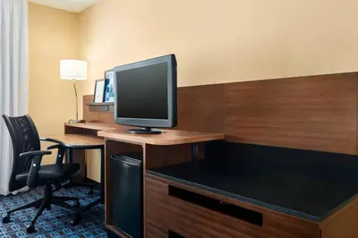 a hotel room with a desk with a television on it at Fairfield Inn by Marriott Roseville in Roseville