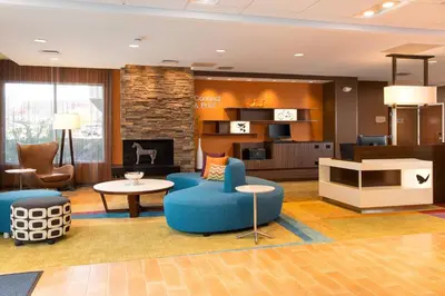 a lobby with a blue chair and a fireplace at Fairfield Inn & Suites by Marriott Sacramento Folsom in Folsom