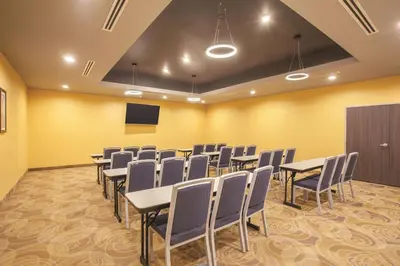 a conference room with tables and chairs and a podium at La Quinta by Wyndham Morgan Hill-San Jose South in Morgan Hill