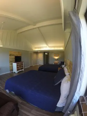 a bedroom with a large blue bed in a room at Ridgemark Golf Club and Resort in Hollister