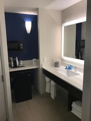 a bathroom with a sink and a mirror at Holiday Inn Express & Suites Tracy by IHG in Tracy