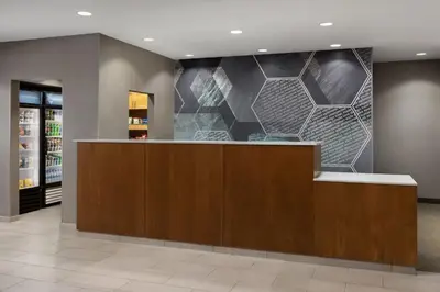 a lobby of a store with a reception desk and a wall at SpringHill Suites Fresno in Fresno