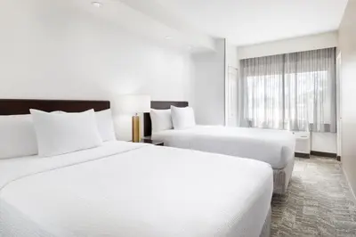 a hotel room with two beds and a window at SpringHill Suites Fresno in Fresno