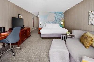 a hotel room with a bed and a couch at Courtyard by Marriott Roseville Galleria Mall/Creekside Ridge Drive in Roseville