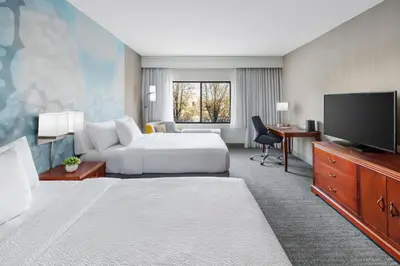 a hotel room with a bed and a flat screen tv at Courtyard by Marriott Roseville Galleria Mall/Creekside Ridge Drive in Roseville