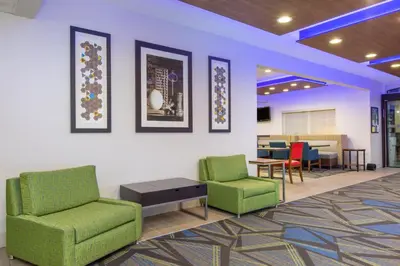 a waiting room with two chairs and a table at Holiday Inn Express Hotel & Suites Bishop by IHG in Bishop