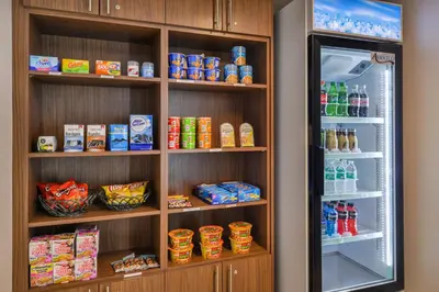 a refrigerator and shelves filled with food and drinks at Holiday Inn Express Westley by IHG in Westley