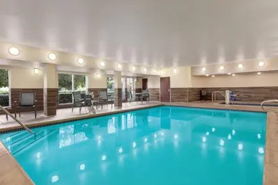a large pool with blue water in a hotel at Fairfield Inn by Marriott Visalia Sequoia in Visalia