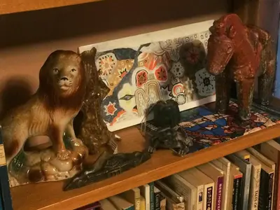 a book shelf with figurines and books on it at Merrynook in Pinehurst