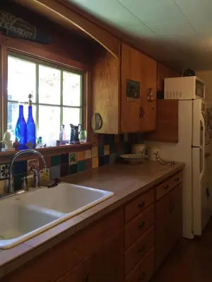 a kitchen with a sink and a white refrigerator at Merrynook in Pinehurst