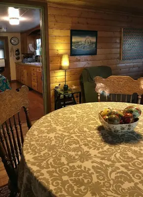 a room with a table with a bowl of fruit on it at Merrynook in Pinehurst