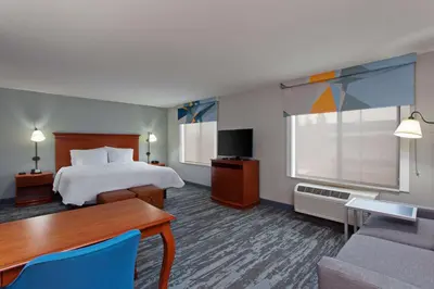 a hotel room with a bed and a table and a couch at Hampton Inn & Suites Clovis Airport North in Clovis