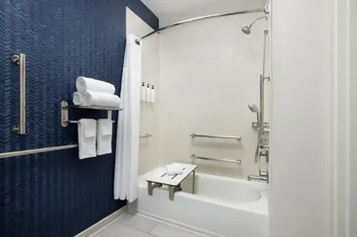 a bathroom with a shower and a toilet and a sink at Fairfield Inn by Marriott Tracy in Tracy