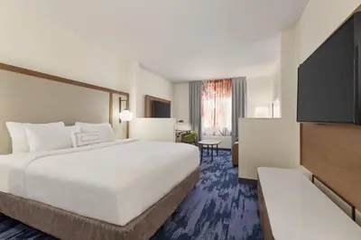 a hotel room with a large bed and a television at Fairfield Inn by Marriott Tracy in Tracy