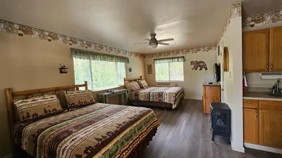 a bedroom with two beds and a ceiling fan at Sequoia Lodge in Kernville