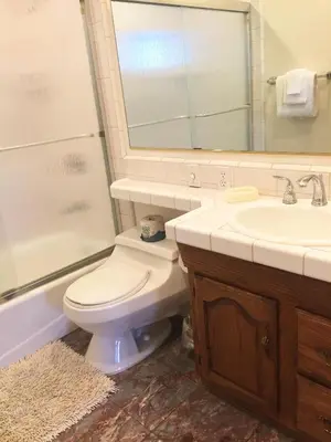 a bathroom with a toilet and a sink and a mirror at Chateau Royal East in Yosemite West