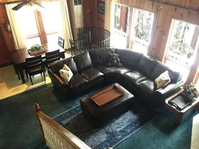 a living room with a leather couch and a table at Chateau Royal East in Yosemite West