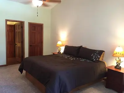 a bedroom with a bed with two lamps on two tables at Alder Lodge in Yosemite West