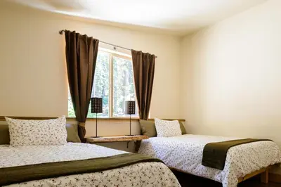 two beds in a room with a window at Alpenglow 3 in Yosemite West