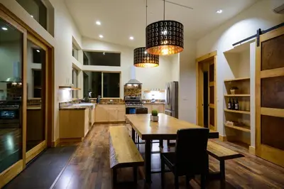 a kitchen with a wooden table and a dining room at Alpenglow 3 in Yosemite West