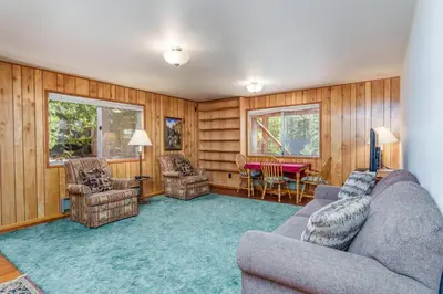 a living room with a couch and chairs and a table at Hutchings Cabin & Apt. in Yosemite West