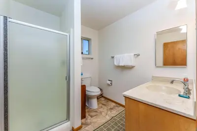 a bathroom with a toilet and a sink and a shower at Hutchings Cabin & Apt. in Yosemite West