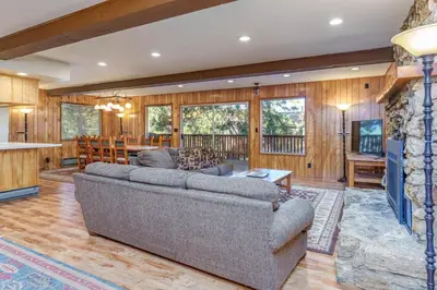 a living room with a couch and a table at Hutchings Cabin & Apt. in Yosemite West