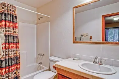 a bathroom with a sink and a toilet and a mirror at Little Sport in Yosemite West