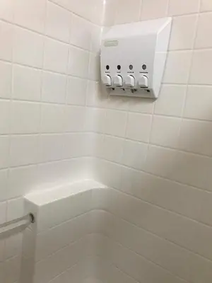 a white tiled bathroom with a toilet and a thermost at Mystic Views in Yosemite West